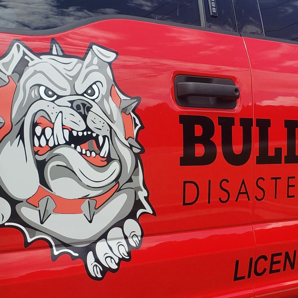 Custom Bulldog Disaster vehicle wrap design on commercial trucks in Loganville Georgia
